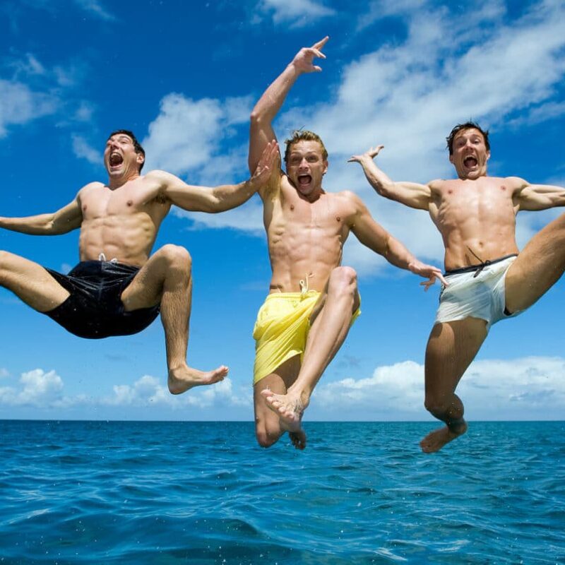 Three young men jumping into the sea Three young men jumping into the sea