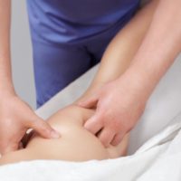The masseur makes Anti-cellulite massage on the buttock and thighs of the patient. The masseur makes Anti-cellulite massage on the buttock and thighs of the patient. Treatment of excess weight.