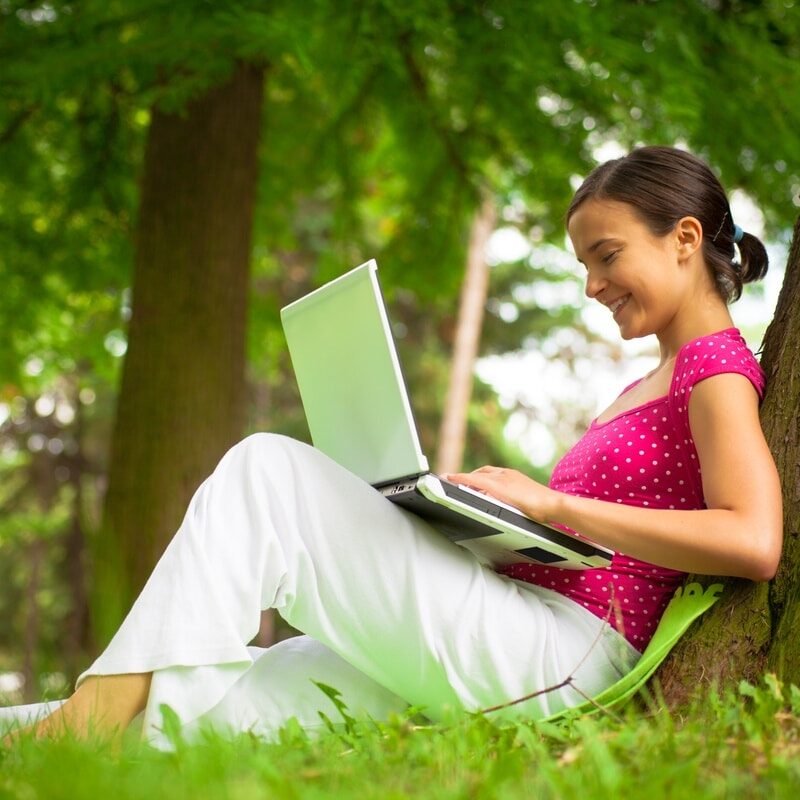 Girl using laptop computer in park pretty girl using laptop computer in park